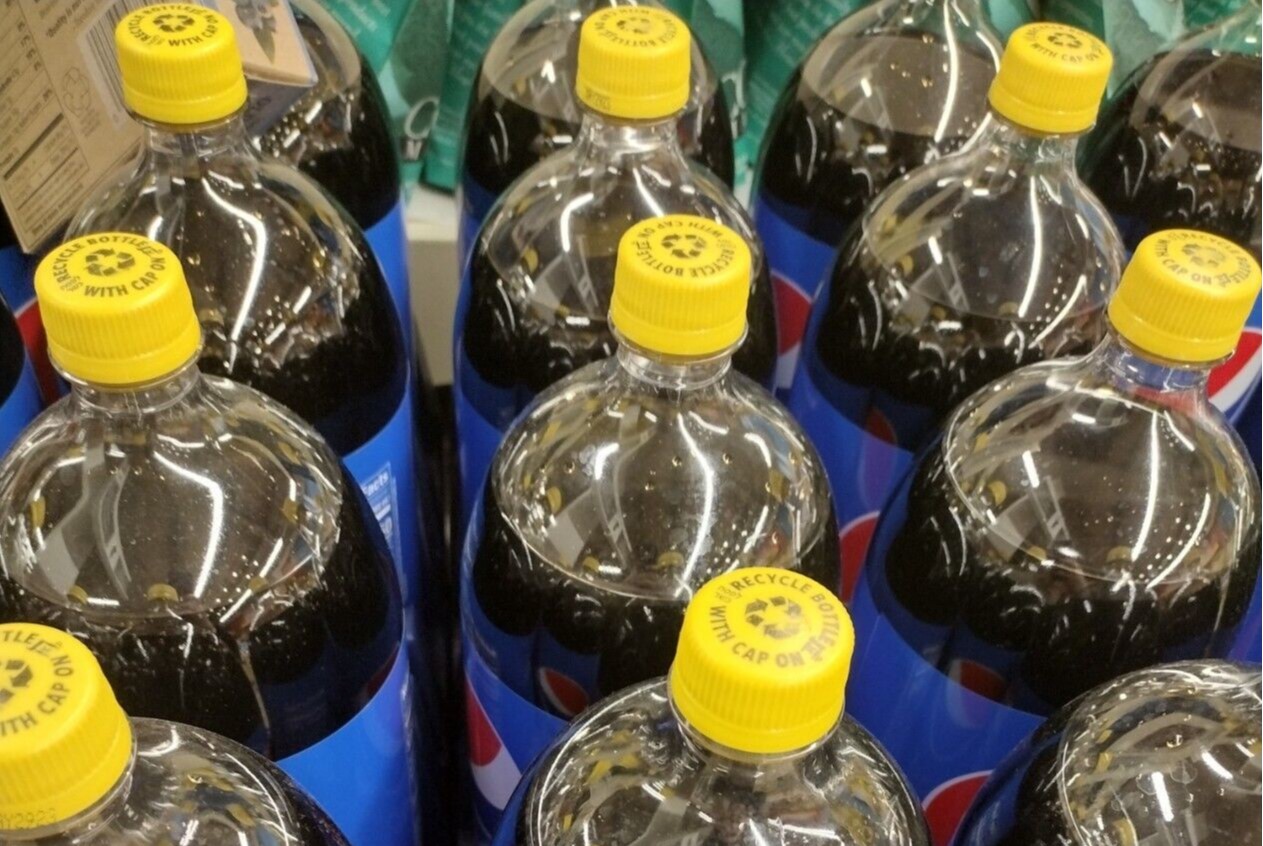 A plastic Pepsi bottle with a bright yellow cap as Pepsi yellow caps confuse consumers.